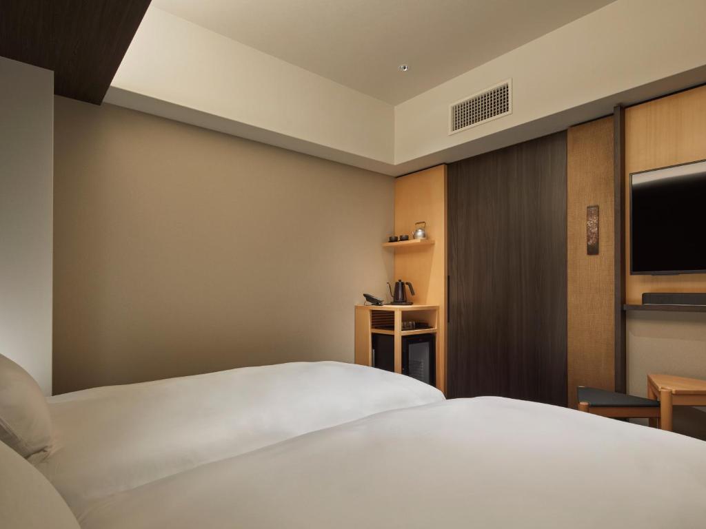 Postel nebo postele na pokoji v ubytování Agora Kyoto Shijo