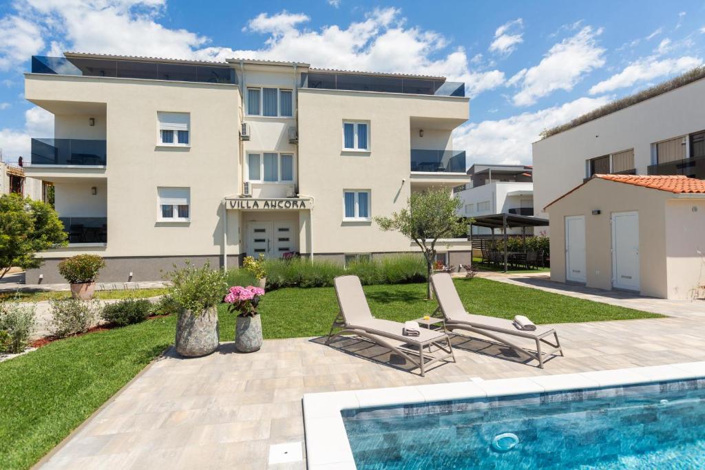 a villa with a swimming pool and a building at Villa Ancora in Rovinj