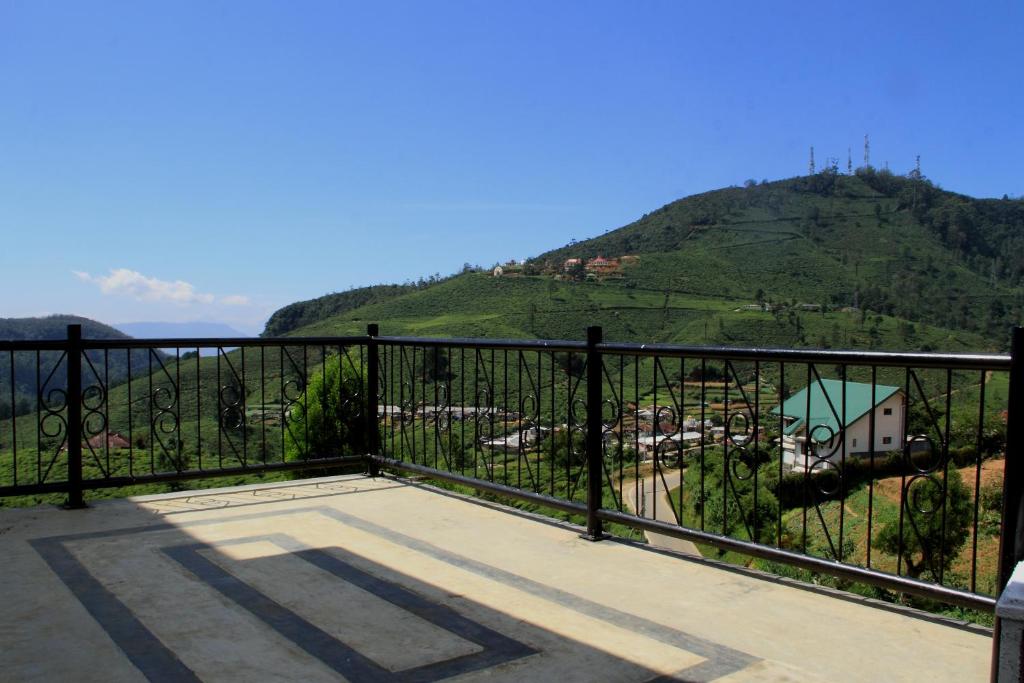 a balcony with a view of a mountain at House of Leisure in Nuwara Eliya