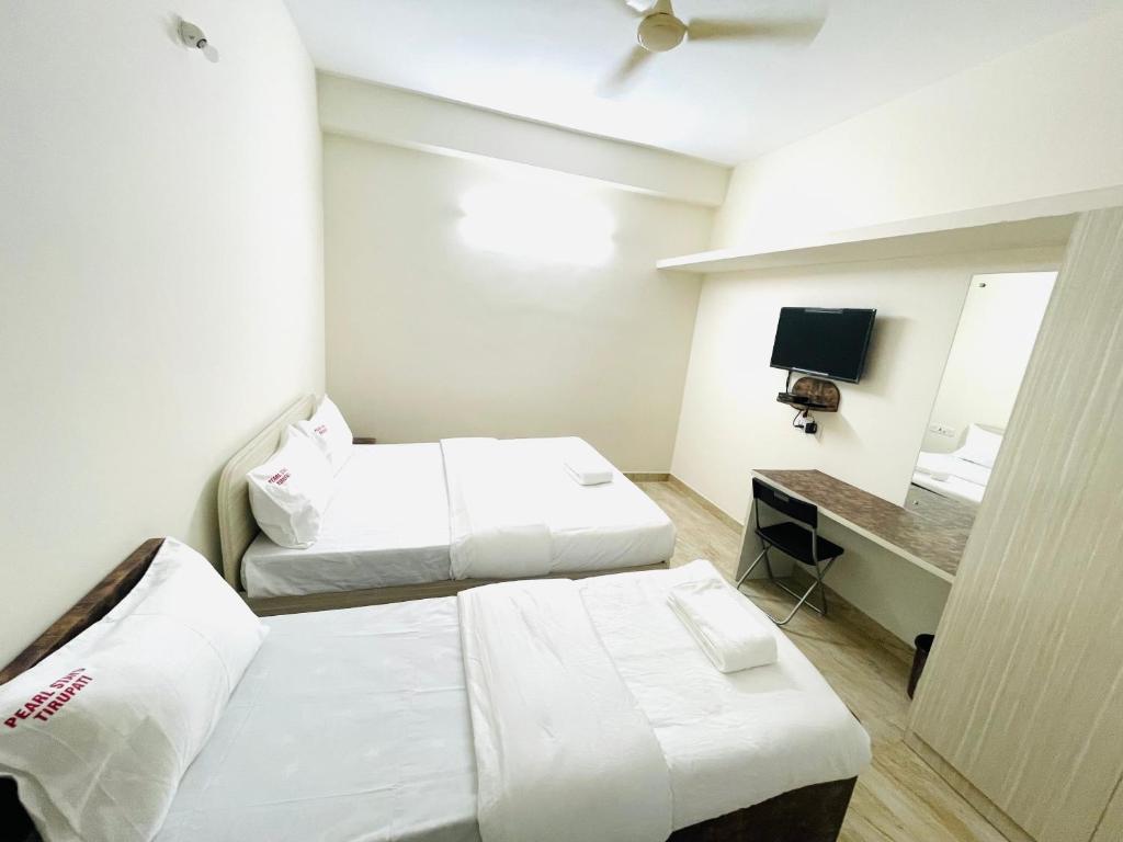 Postel nebo postele na pokoji v ubytování Pearl Stays, Tirupati - Very convenient for the people coming from Bangalore and Chennai - You can skip city traffic while reaching any temple in Tirupati - Covered Parking - 24hrs Front Desk and Hot Water - Free WiFi - Flexible Checkin-in Check-out times