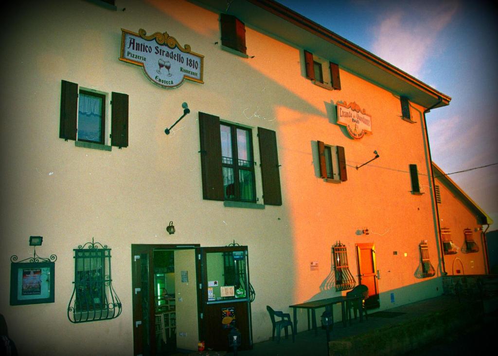 een oranje en wit gebouw met een tafel ervoor bij Locanda del Viandante in Loiano