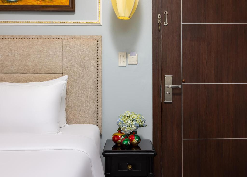 Postel nebo postele na pokoji v ubytování Golden Amour Hotel
