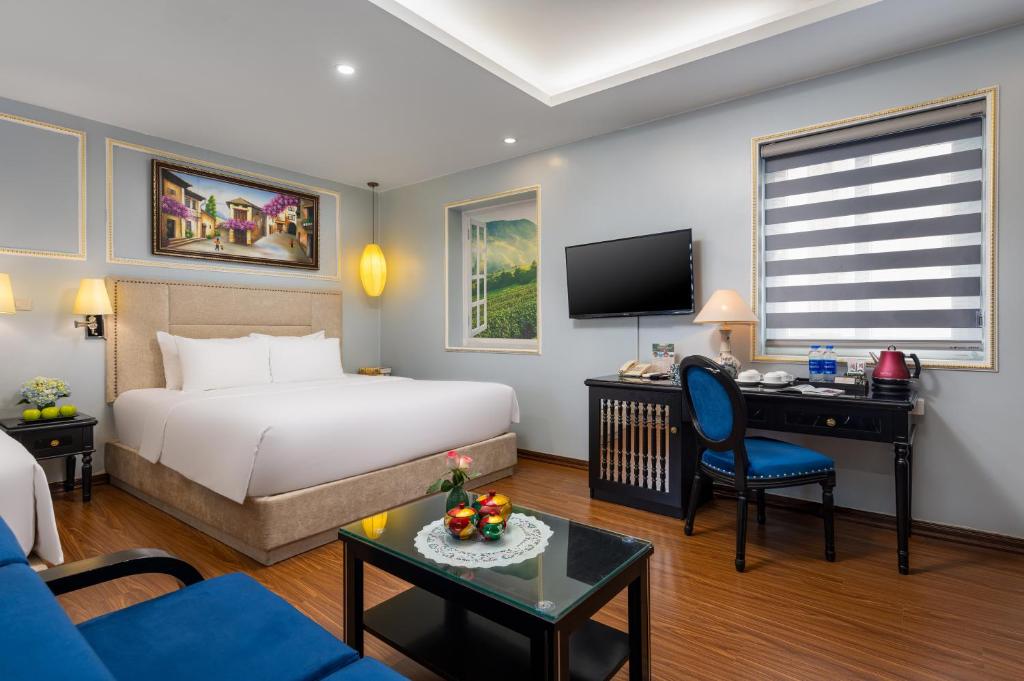 Postel nebo postele na pokoji v ubytování Golden Amour Hotel