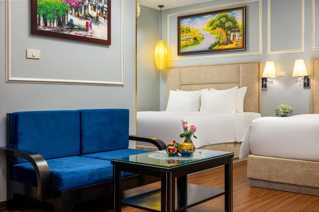 Postel nebo postele na pokoji v ubytování Golden Amour Hotel