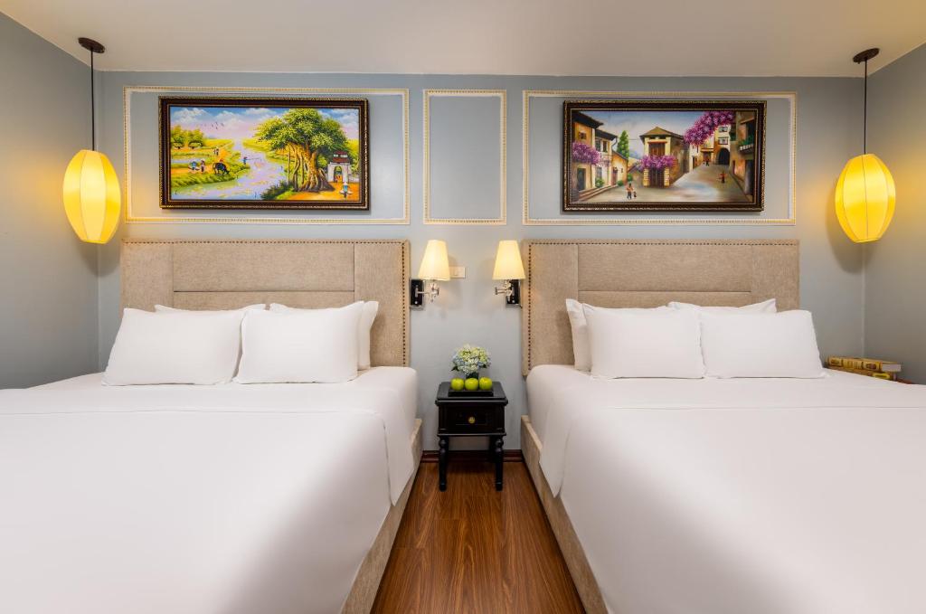 Postel nebo postele na pokoji v ubytování Golden Amour Hotel