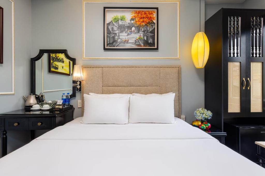 Postel nebo postele na pokoji v ubytování Golden Amour Hotel