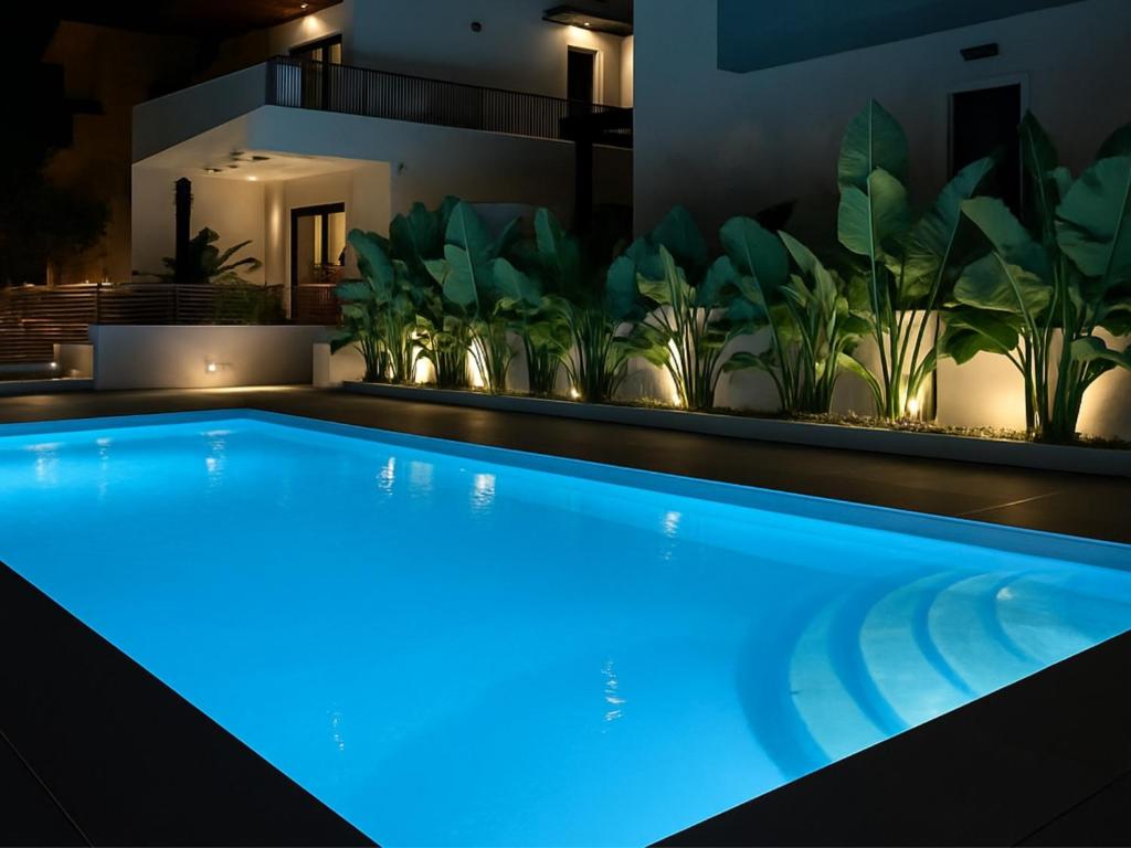 a swimming pool with blue lighting in a house with plants at Diamond D2 Iraklitsa in Iraklitsa