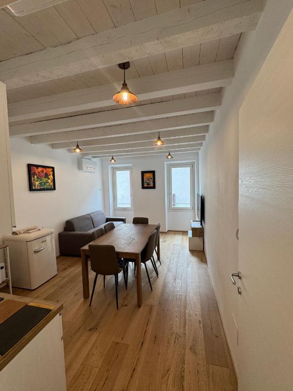 a living room with a table and a couch at Loggia Tre Piazze Apartments in Brescia