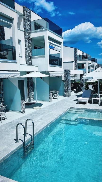 a swimming pool in front of a building at INTERNI LUXURY LIVING b in Nikiti