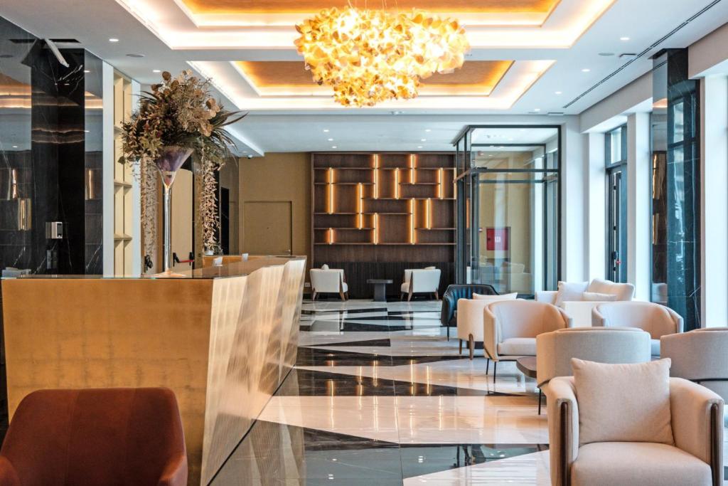 a lobby of a hotel with chairs and a bar at Zep Promenade Spa Apartment in Vrnjačka Banja