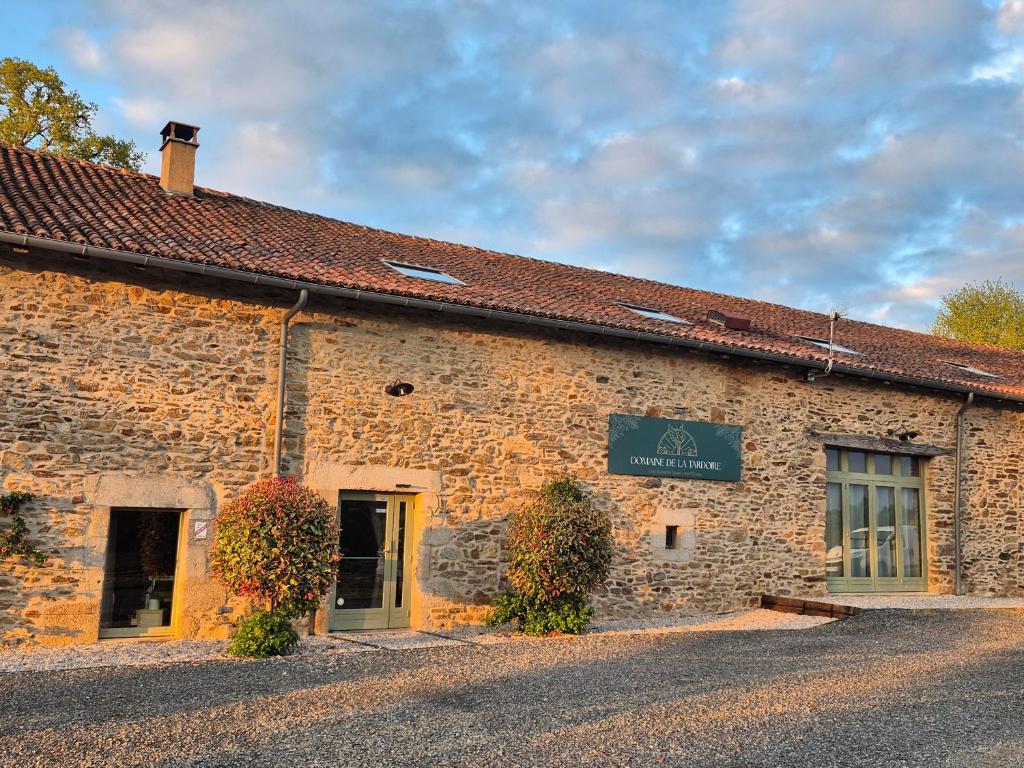 a brick building with a sign on the side of it at Domaine de la Tardoire in Oradour-sur-Vayres