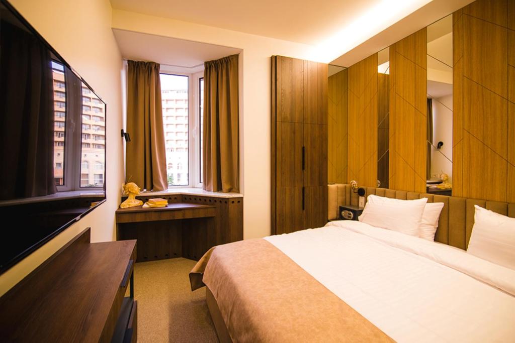 Postel nebo postele na pokoji v ubytování Cartez Hotel