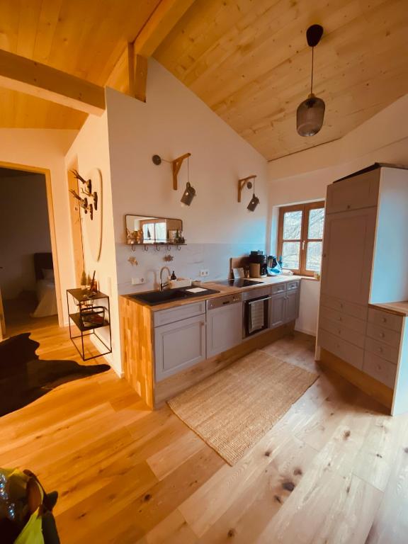 a large kitchen with a sink and a counter at Gästehäuschen mit Kamin in Gauting