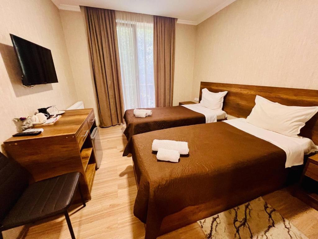 Postel nebo postele na pokoji v ubytování Kisi Garden Hotel