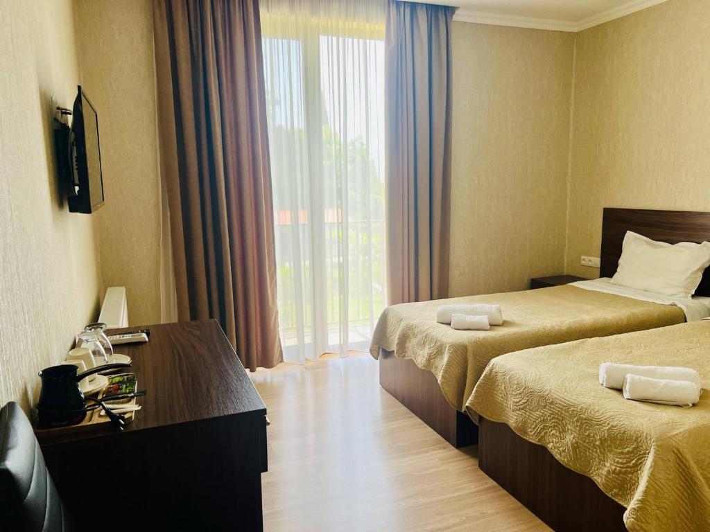 Postel nebo postele na pokoji v ubytování Kisi Garden Hotel