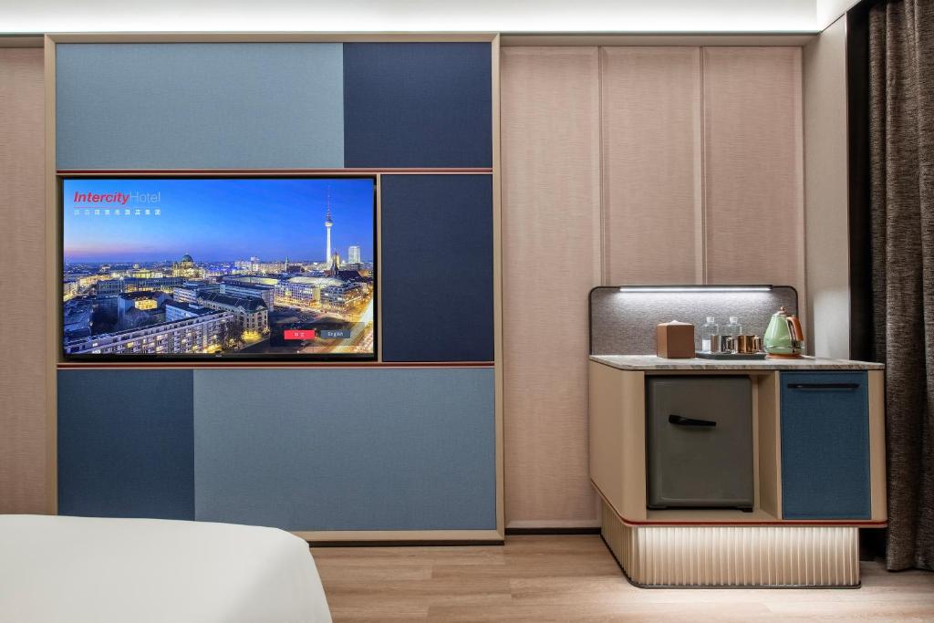 a hotel room with a view of a city at IntercityHotel Shanghai Hongqiao Airport - Free Minibar for First Night in Shanghai