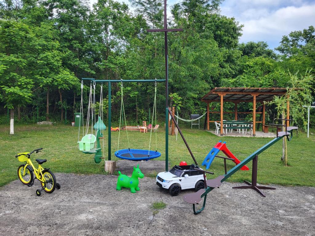 a playground with toys and a swing set at Apartmani Eli SA DVORIŠTEM in Veliko Gradište