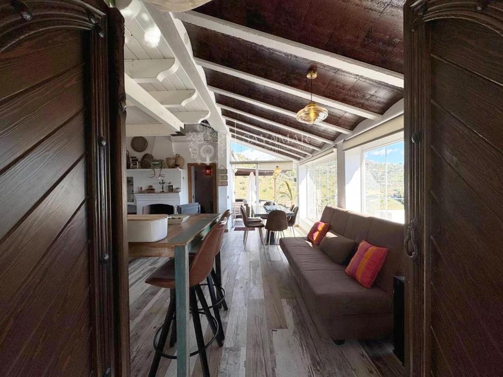 a living room with a couch and a table at Cortijo Los Matías in Sayalonga