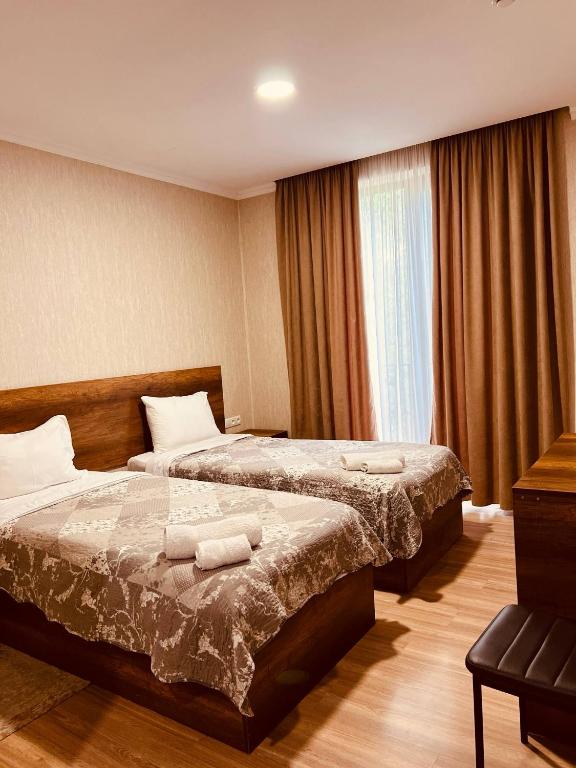 Postel nebo postele na pokoji v ubytování Kisi Garden Hotel