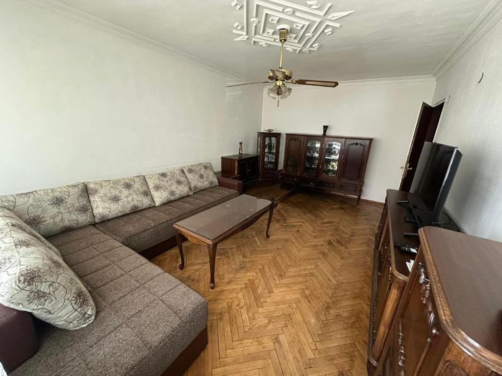 a living room with a couch and a television at J Family Budget in Vidin