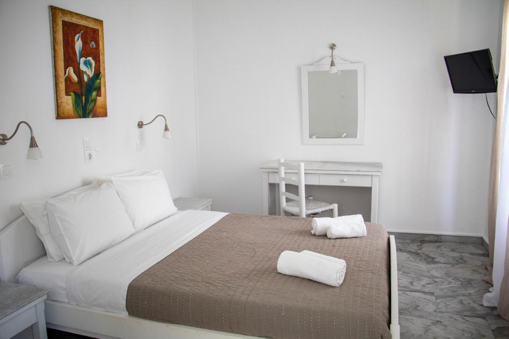Postel nebo postele na pokoji v ubytování Hotel Manos