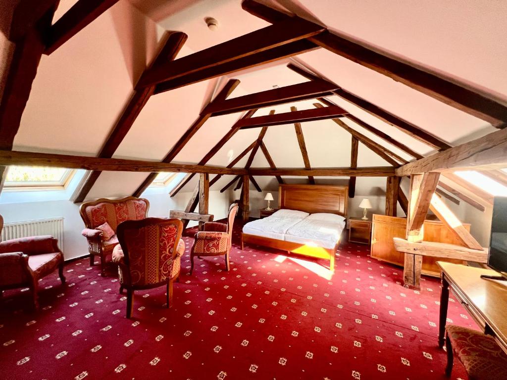 a bedroom with a bed and a table and chairs at Ludwig - penzión&reštaurácia in Prešov