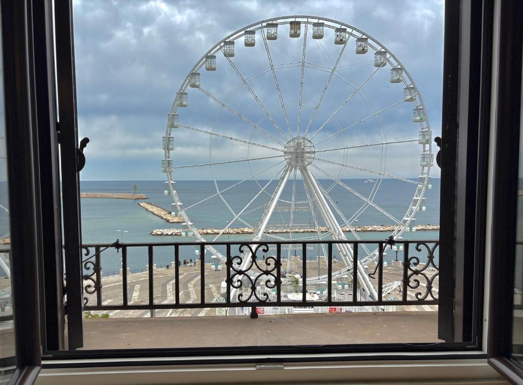 a view of a ferris wheel from a window at 8 Archi sul Mare Exclusive Ferris Wheel View in Bari