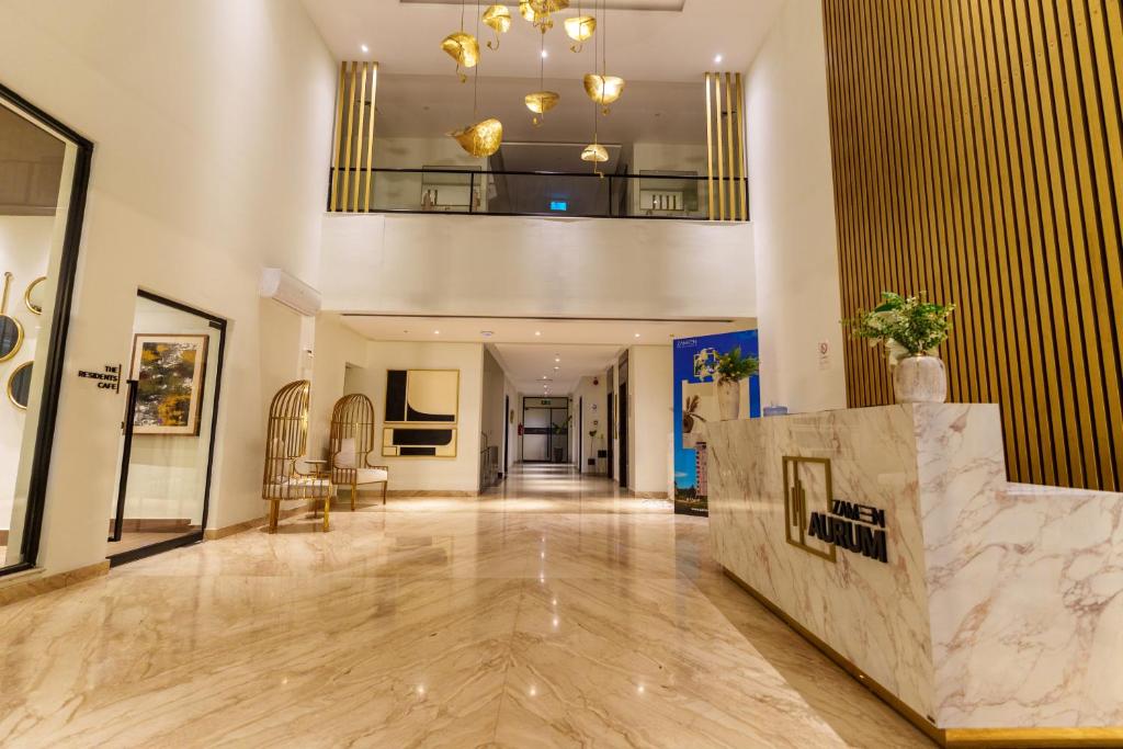 an empty lobby with a staircase in a building at Luxor Apartments & Suites - Aurum in Lahore
