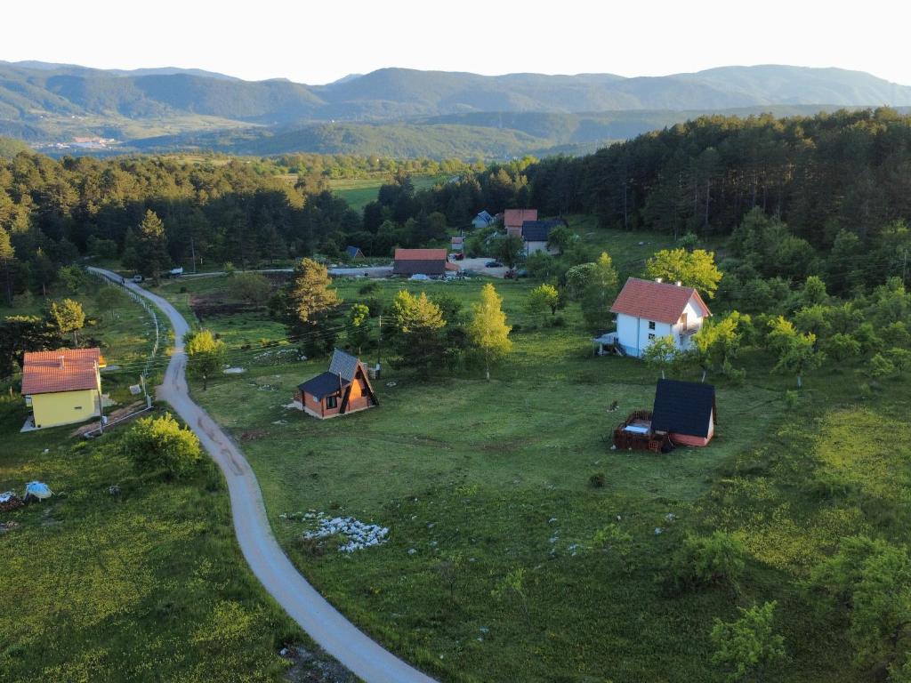 an aerial view of a village with tents and a road at A Pine vikendica u srcu Zapadne Srbije in Nova Varoš