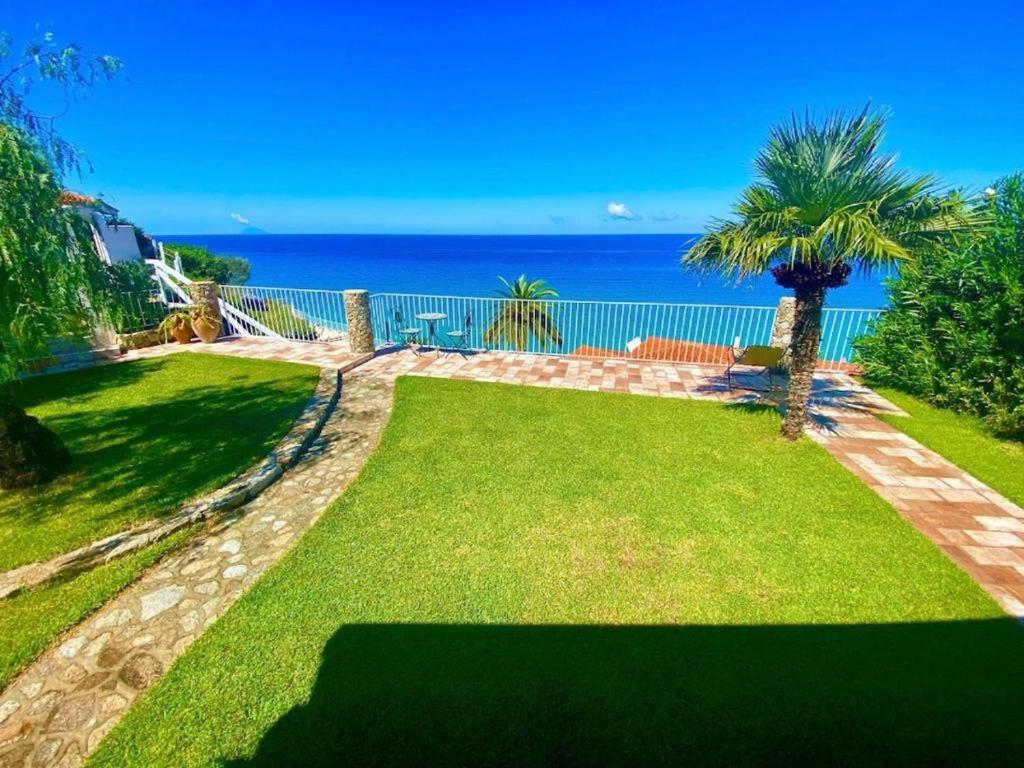 a garden with a view of the ocean at Villa Taurus Costa dei Monaci Parghelia Tropea in Parghelia