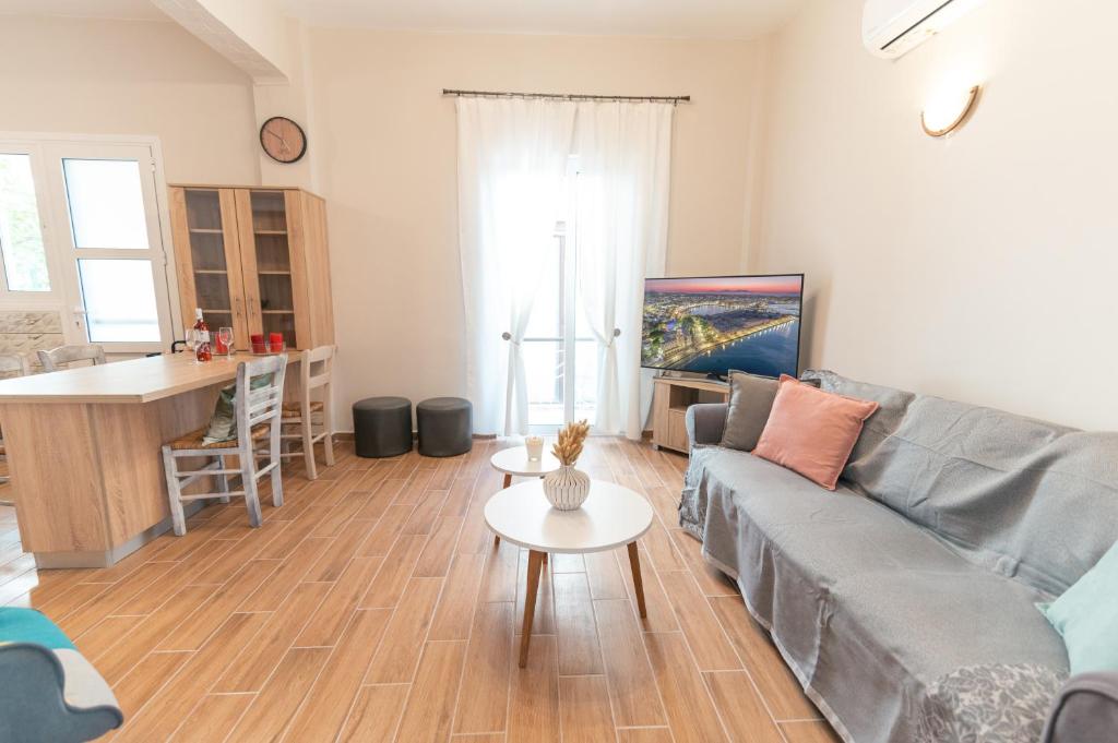 a living room with a couch and a table at Skyard - Central 2bd House in Kos