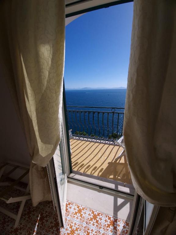 a view of the ocean from the balcony of a condo at Hotel La Perla in Praiano
