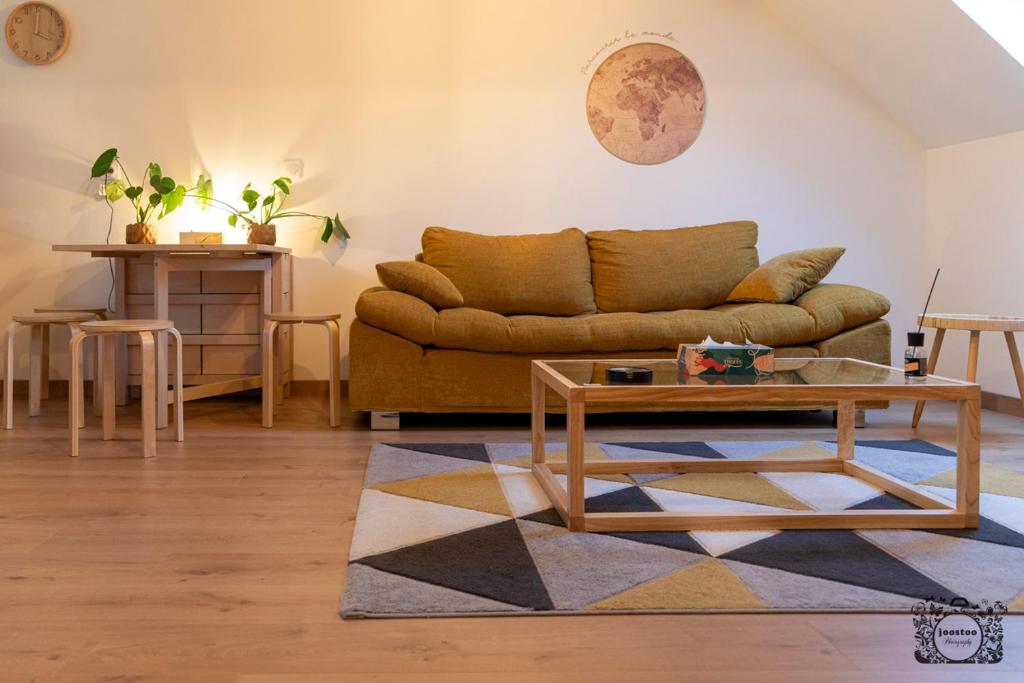 a living room with a couch and a table at Joli appartement Cosy in Nogent-sur-Seine