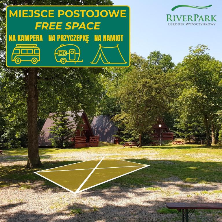 a sign in a park with a basketball court at Kemping i Pole Namiotowe River Park Zator SPA RESORT in Zator