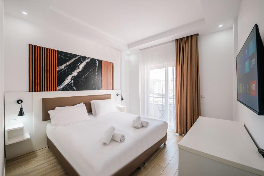 Postel nebo postele na pokoji v ubytování Helia Seaside Hotel