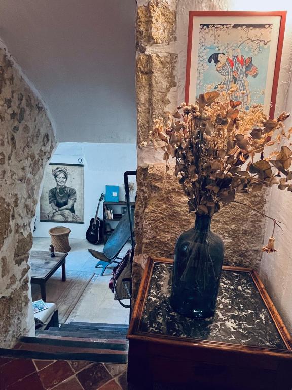 un vase avec des fleurs sur une table dans une pièce dans l'établissement La Biscornue, à Lauris