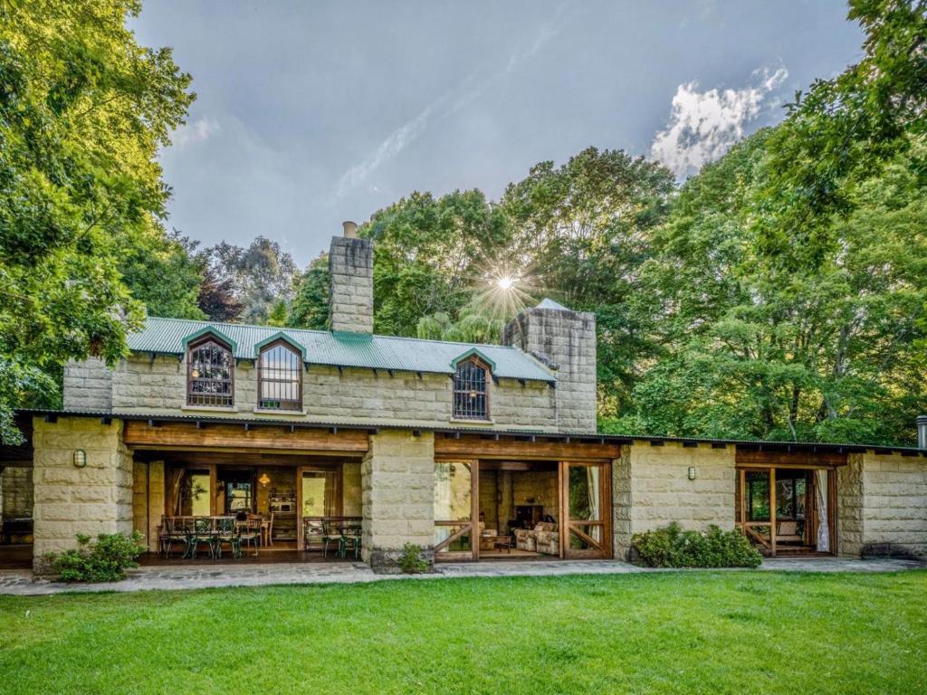 an exterior view of a large stone house at Glentowy Farm Underberg in Underberg