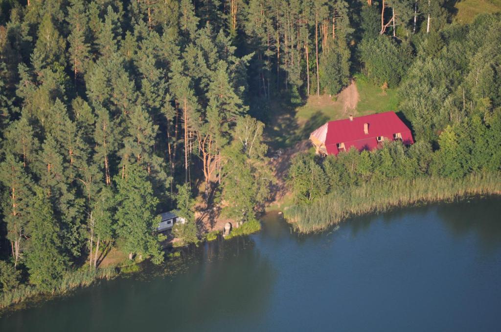 an aerial view of a house on the shore of a lake at Ilzezers in Aglona