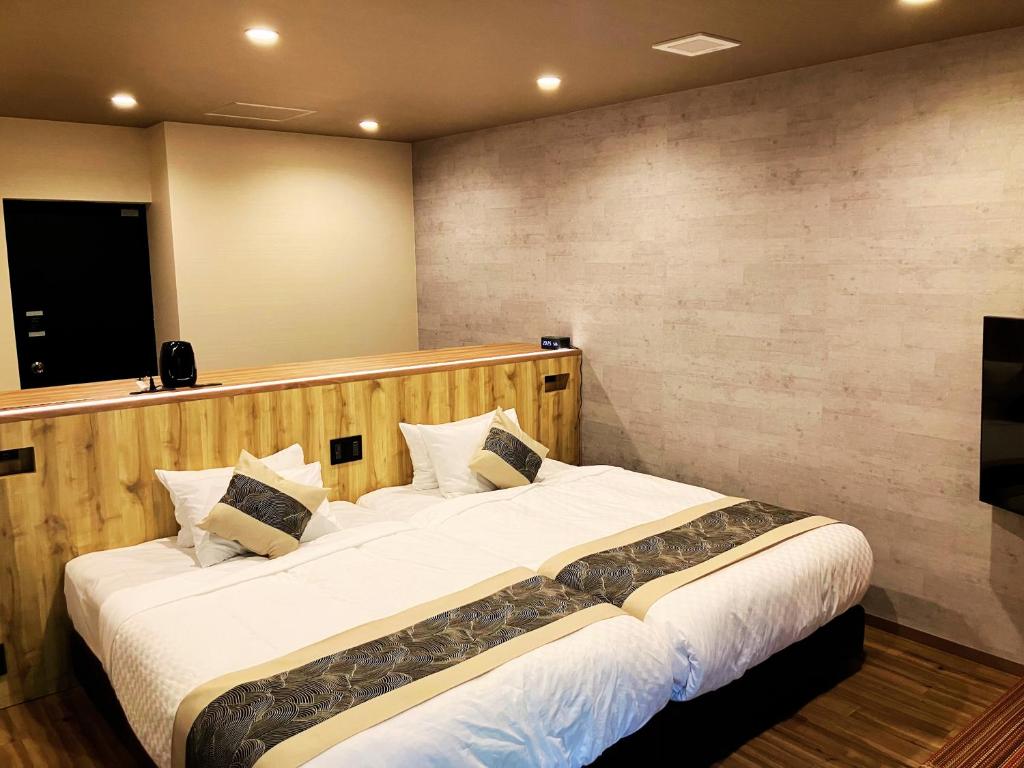 Postel nebo postele na pokoji v ubytování Livemax Resort Sanuki Shionoe Onsen