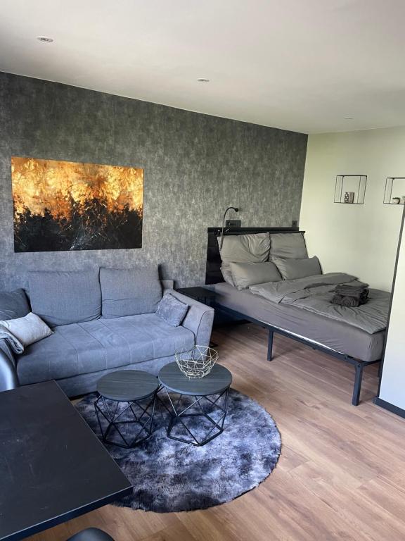 a living room with a couch and a bed at RHE036-008 Apartment Bremerhaven in Bremerhaven