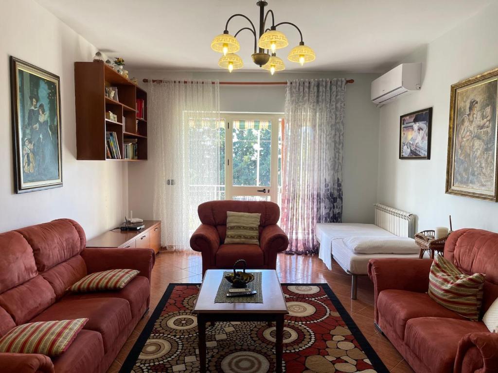 a living room with a couch and a table at Vila Tahiri 4 in Golem