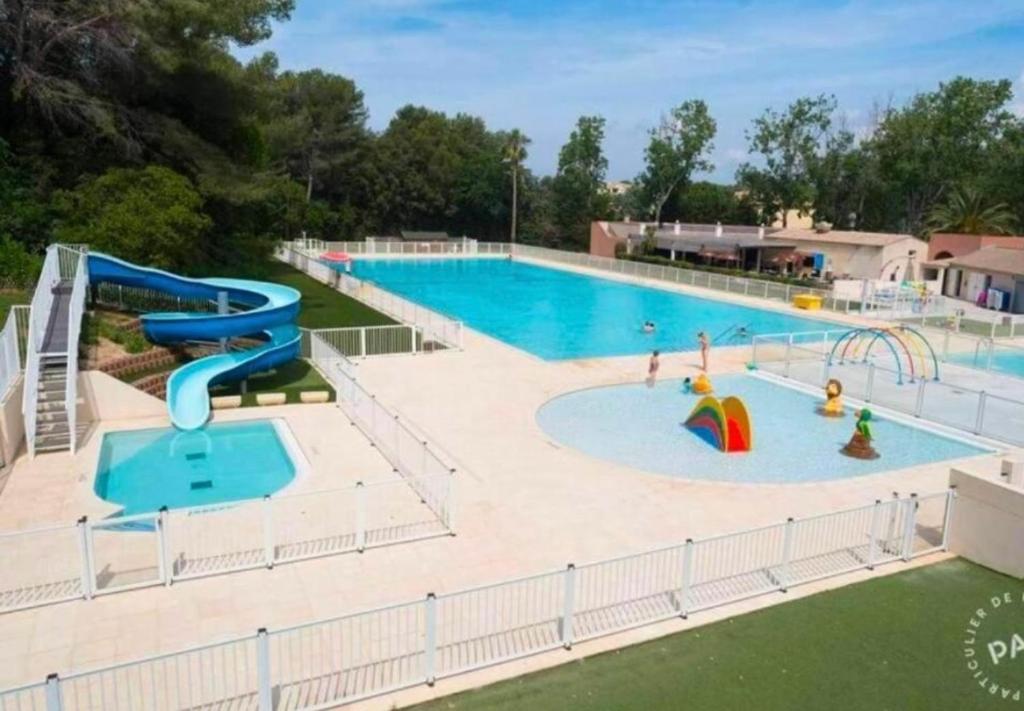 une grande piscine avec toboggan et un parc aquatique dans l'établissement Domaine de la Coudouliere - Studio, à Six-Fours-les-Plages