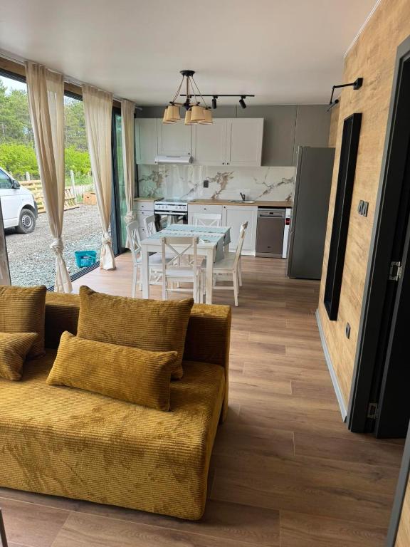 a living room with a couch and a table at Еко Къмпинг Созопол in Sozopol