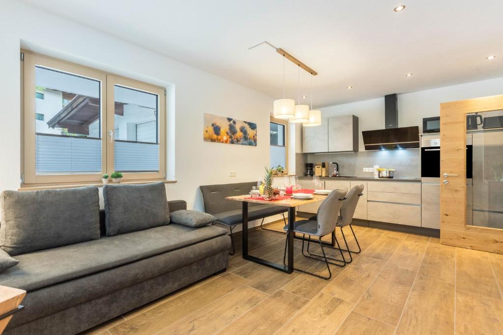 a living room with a couch and a table at Appartment Dorfblick in Wildschönau