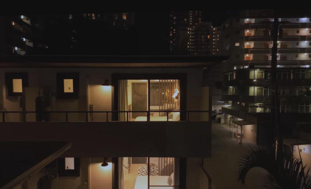 a night view of a building with a balcony at The Walk-Up Waikiki Beach in Honolulu