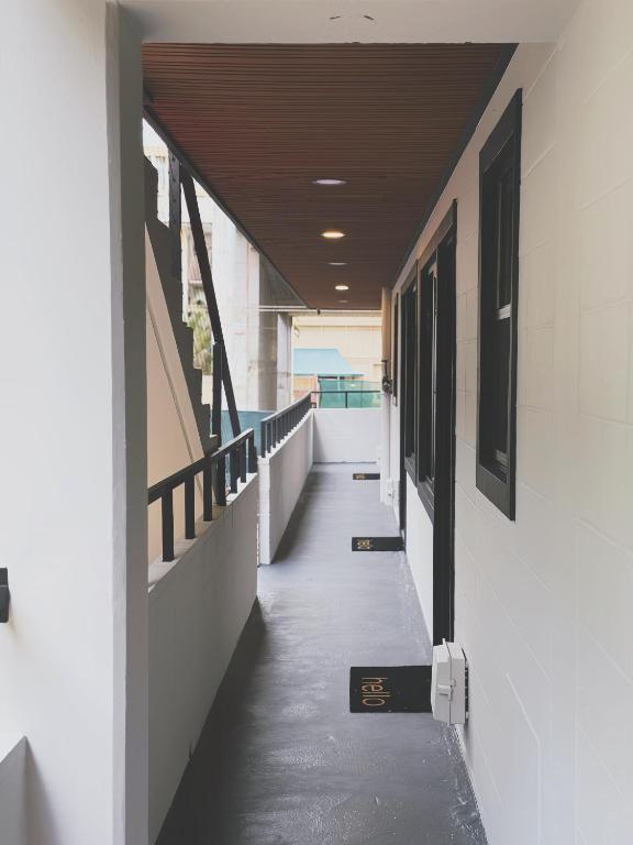 a hallway of a building with a clock on it at The Walk-Up Waikiki Beach in Honolulu