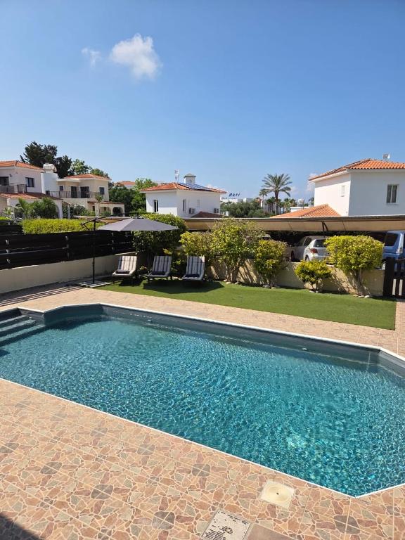 a swimming pool in front of a house at Marinea 2 in Paphos