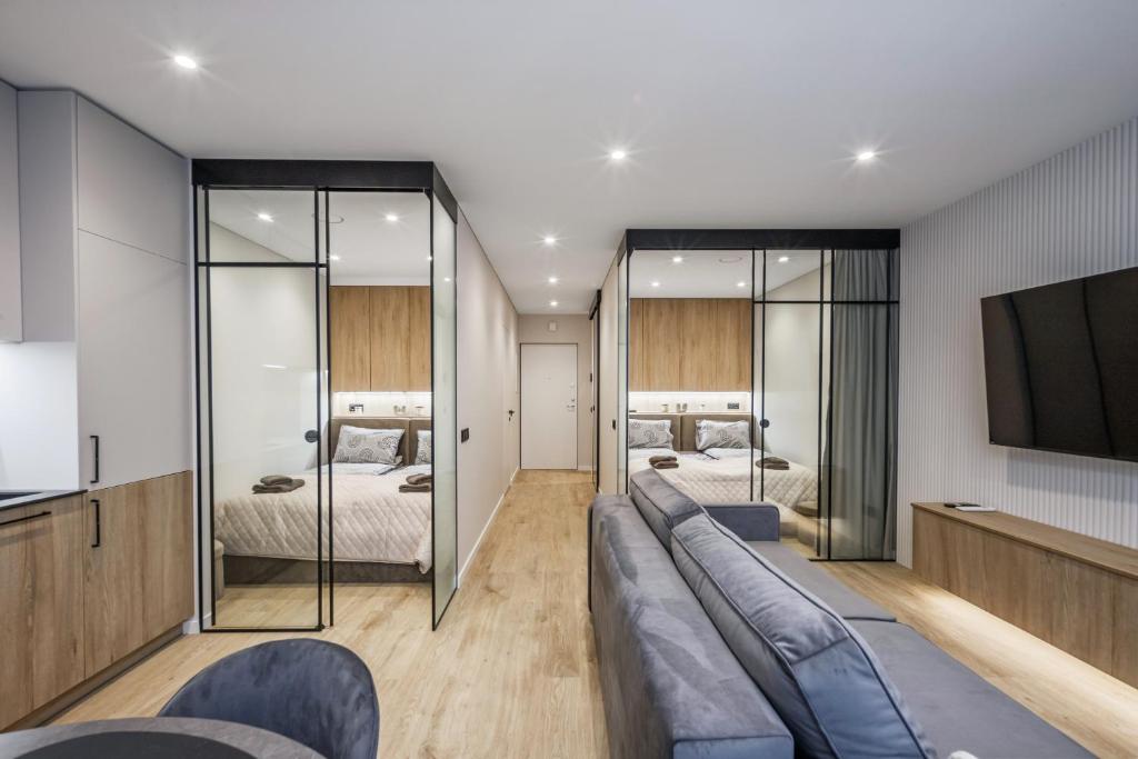 a living room with a couch and two beds at Sea Whisper apartamentai Daukanto g Palanga in Palanga