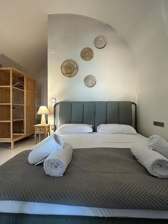a bedroom with a large bed with two pillows at Arch Residence, studio 3, Vroulidia in Katarráktis