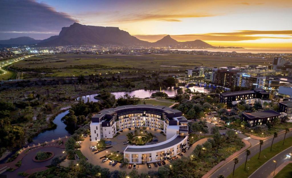 an aerial view of a building with mountains in the background at Table Mountain View Apartment in Cape Town